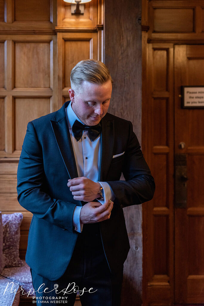 Groom adjusting his cufflinks