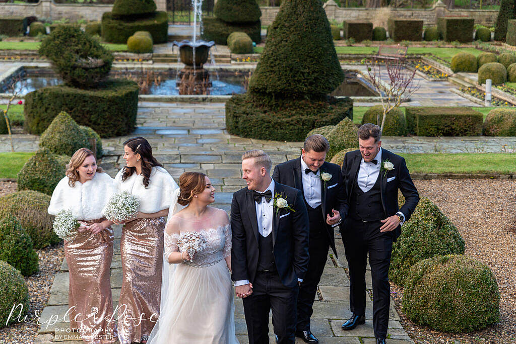 Bride and groom laughing with the wedding party