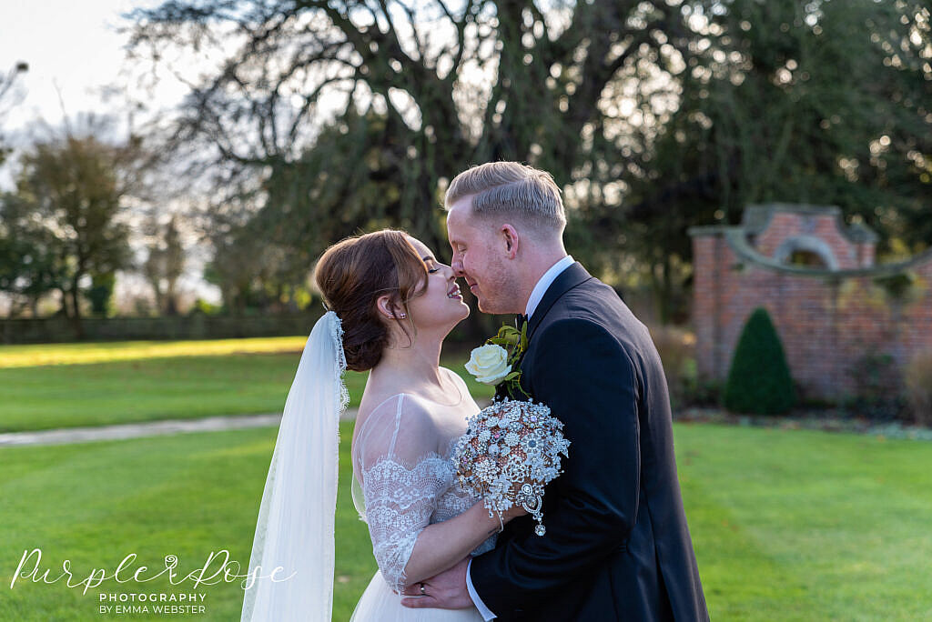 Bride and groom touching noses