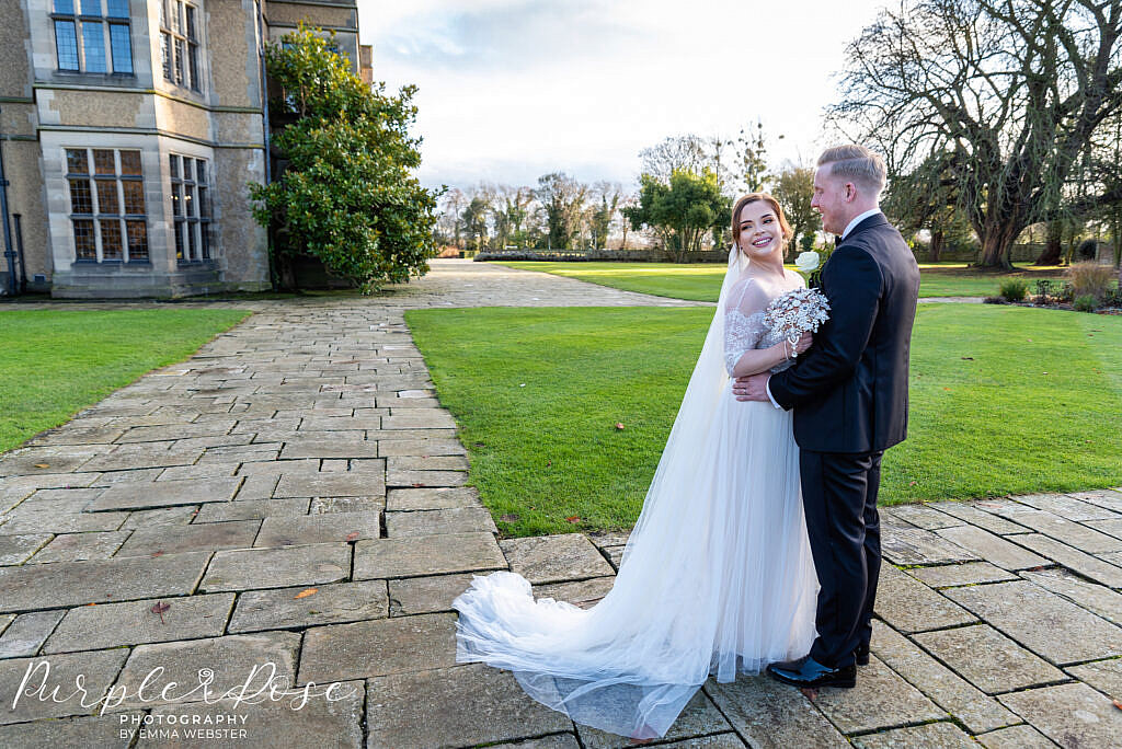 Bride and groom standing in gardens