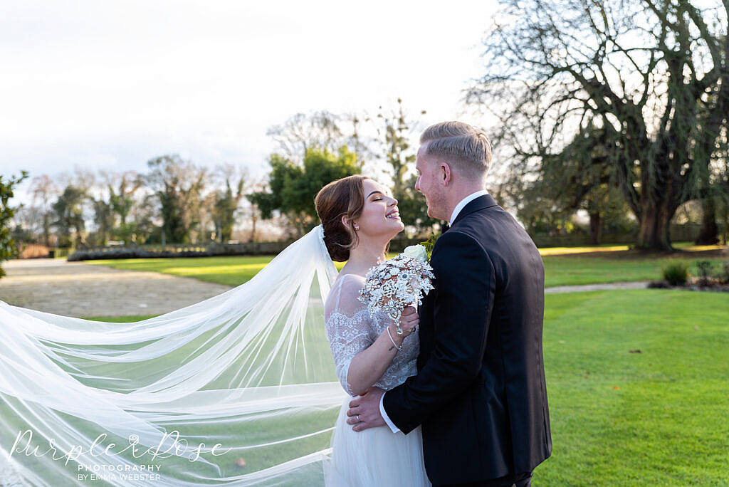 Brides veil swirling around the couple