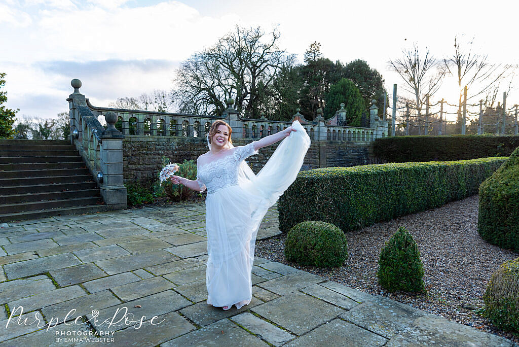 Bride playing with her wedding dress