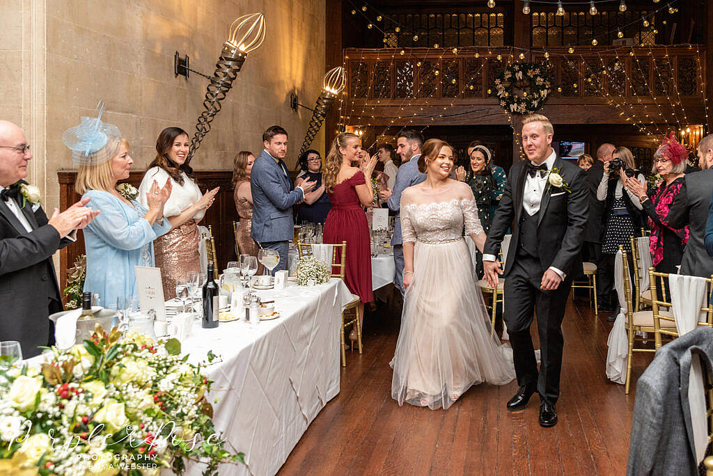 Bride and groom walking into their wedding reception