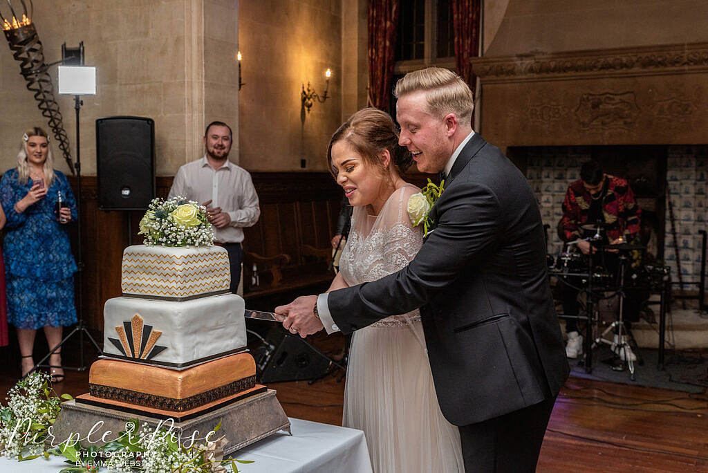 Bride and groom cutting their wedding cake