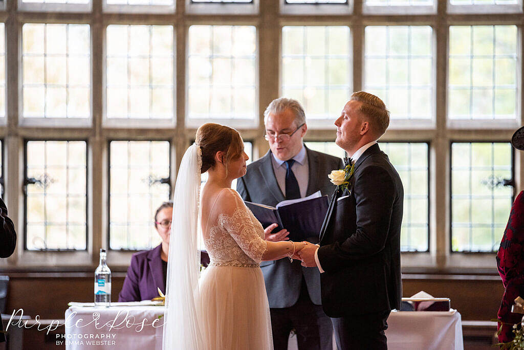 Bride and groom holding hands during the wedding ceremony