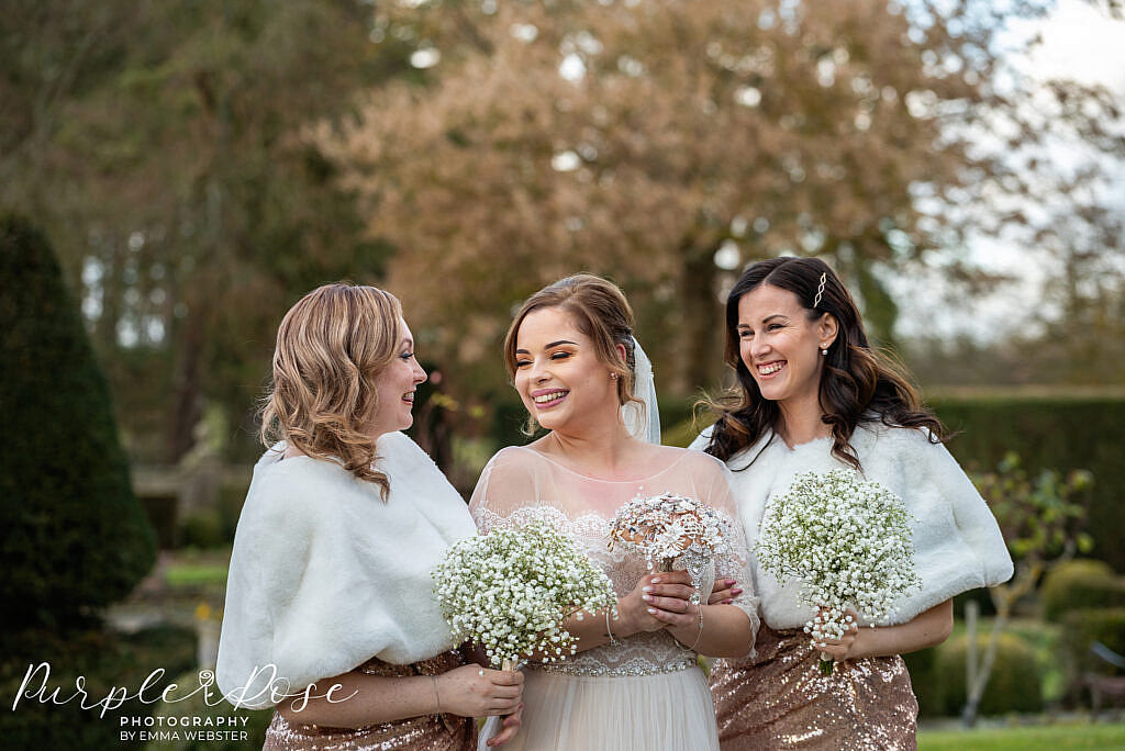 Bride laughing with her bridesmaids