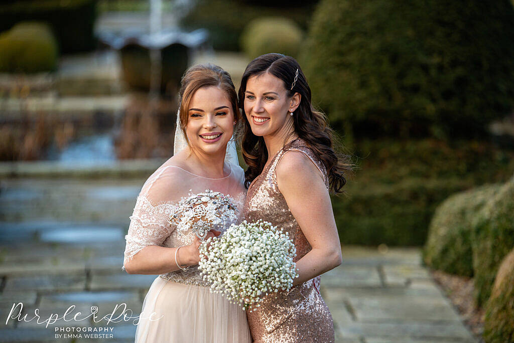 Bride smiling with her bridesmaid