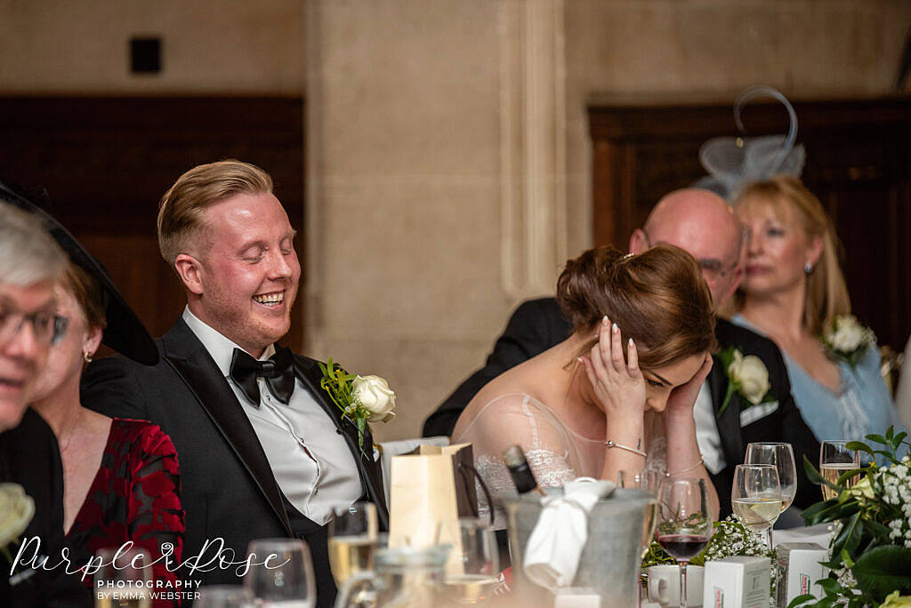 Bride and groom laughing during the speeches