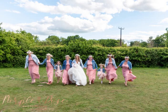 Bride and bridesmaids skipping