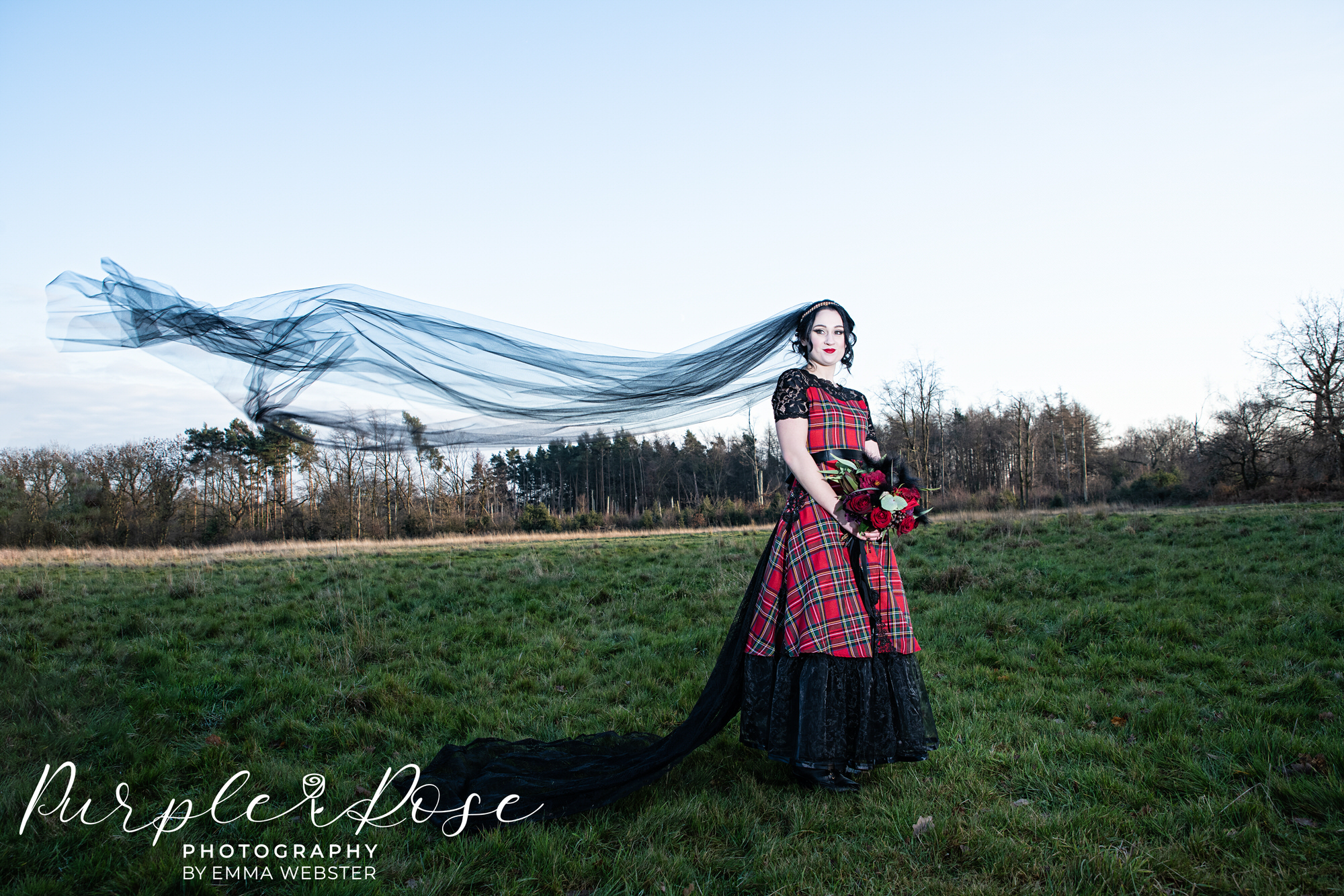 Gothic bride with black wedding veil flowing behind her