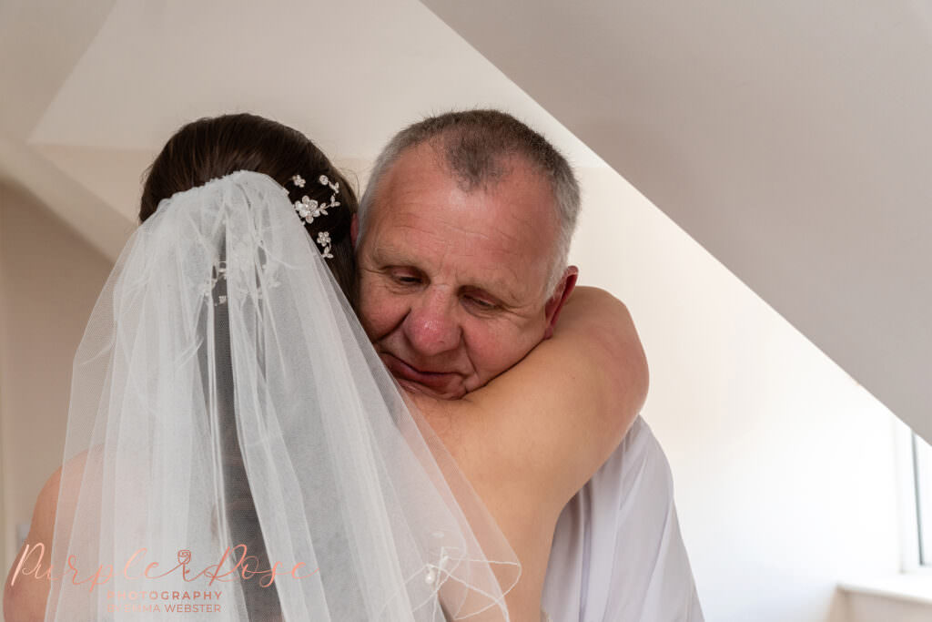 Father hugging his daughter on her wedding day