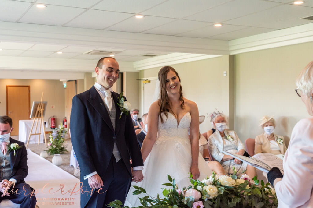 Bride and groom holding hands during their wedding ceremony