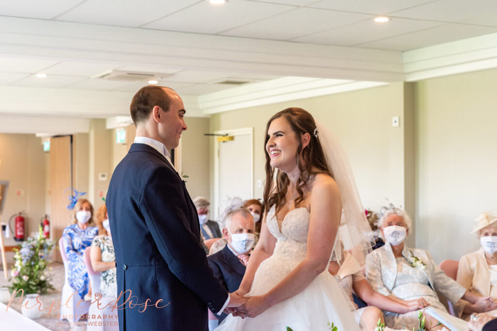 Bride and groom laughing during their wedding ceremony