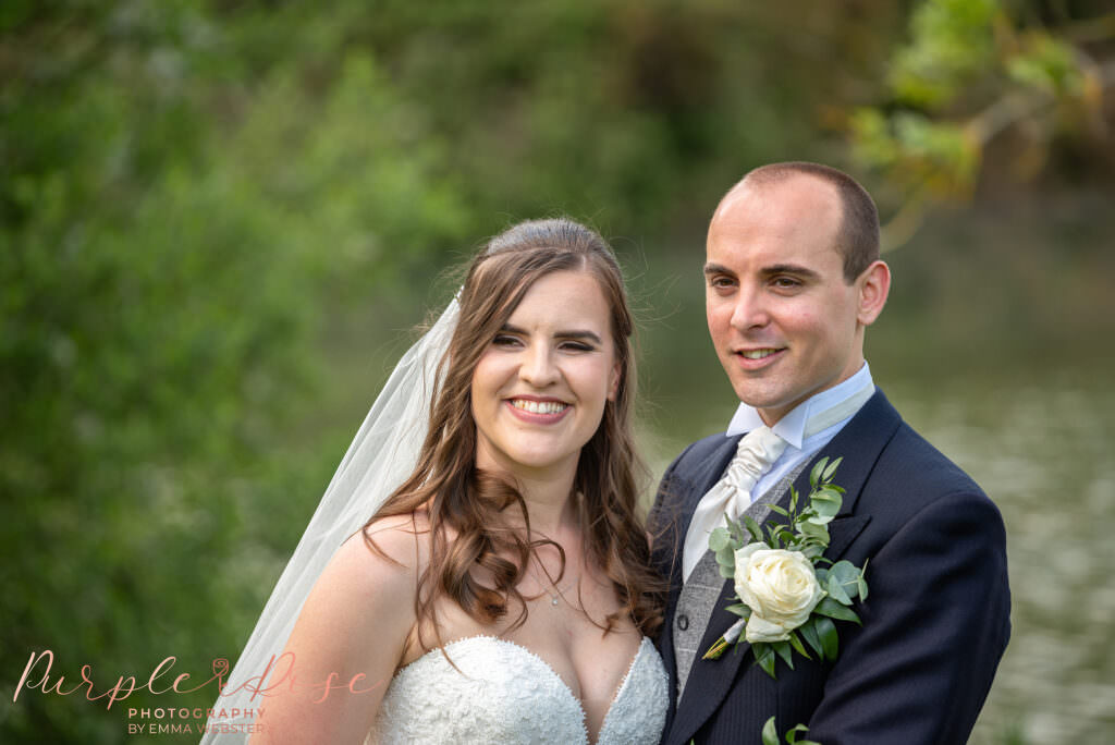 Bride and groom surrounded by greenery