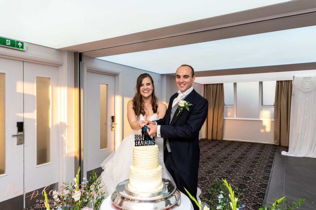 Bride and groom cutting their wedding cake