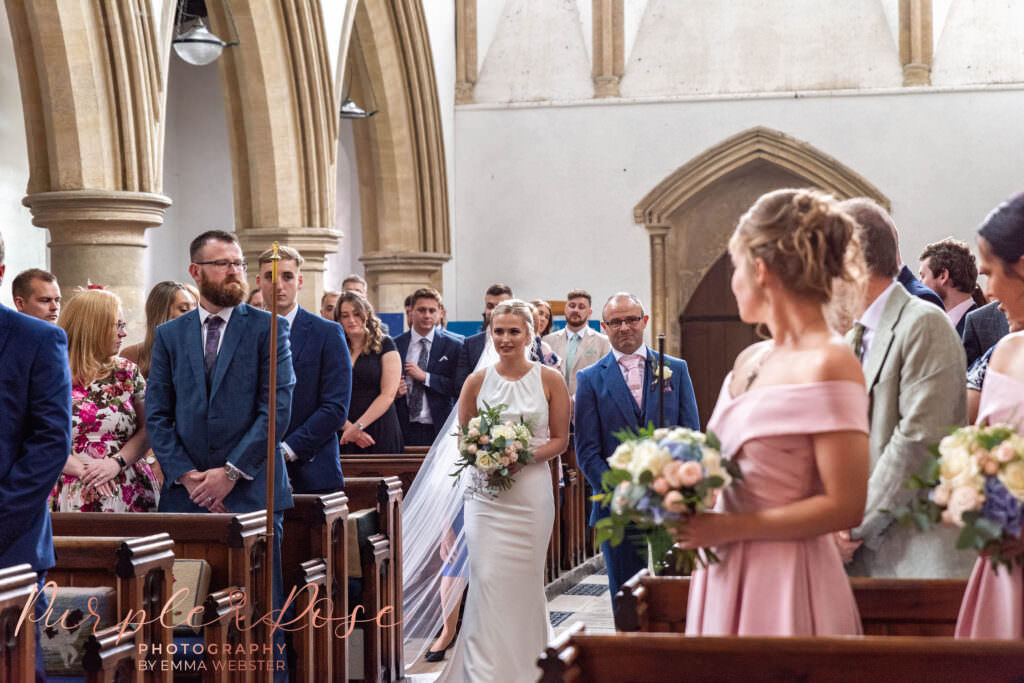 Bride walking with her father through the church