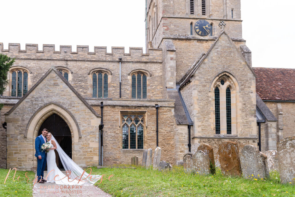 Bride and groom stood in front of their church