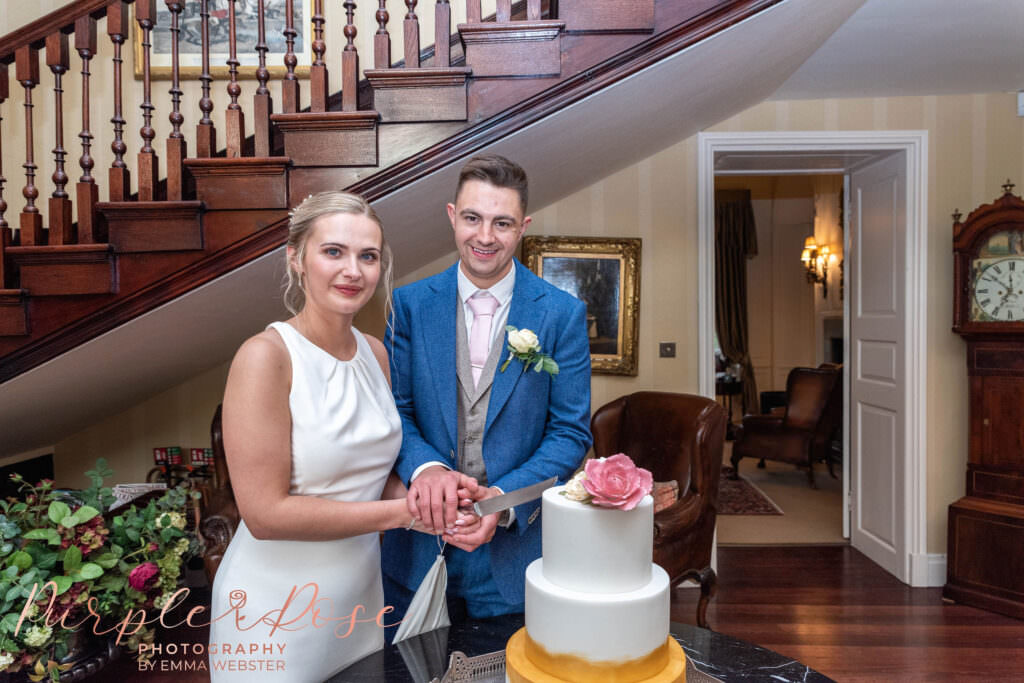 Bride and groom cutting their wedding cake