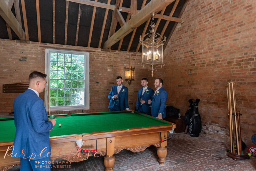 Groomsmen playing pool