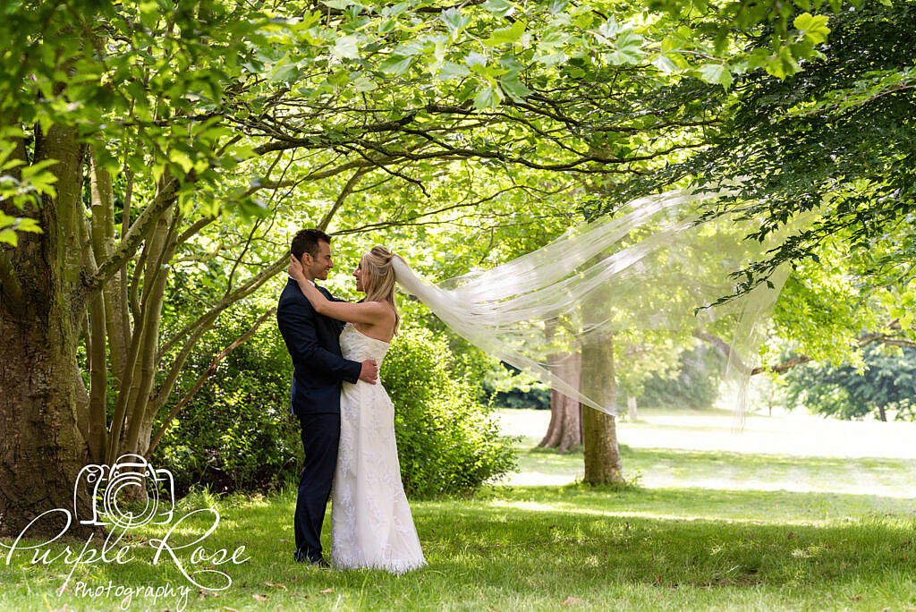 Bride and groom embracing in a forest