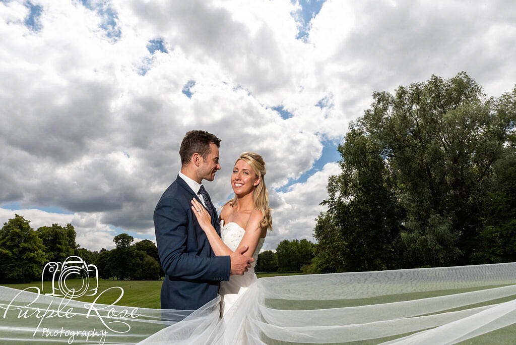 Bride and groom under s dramatic sky