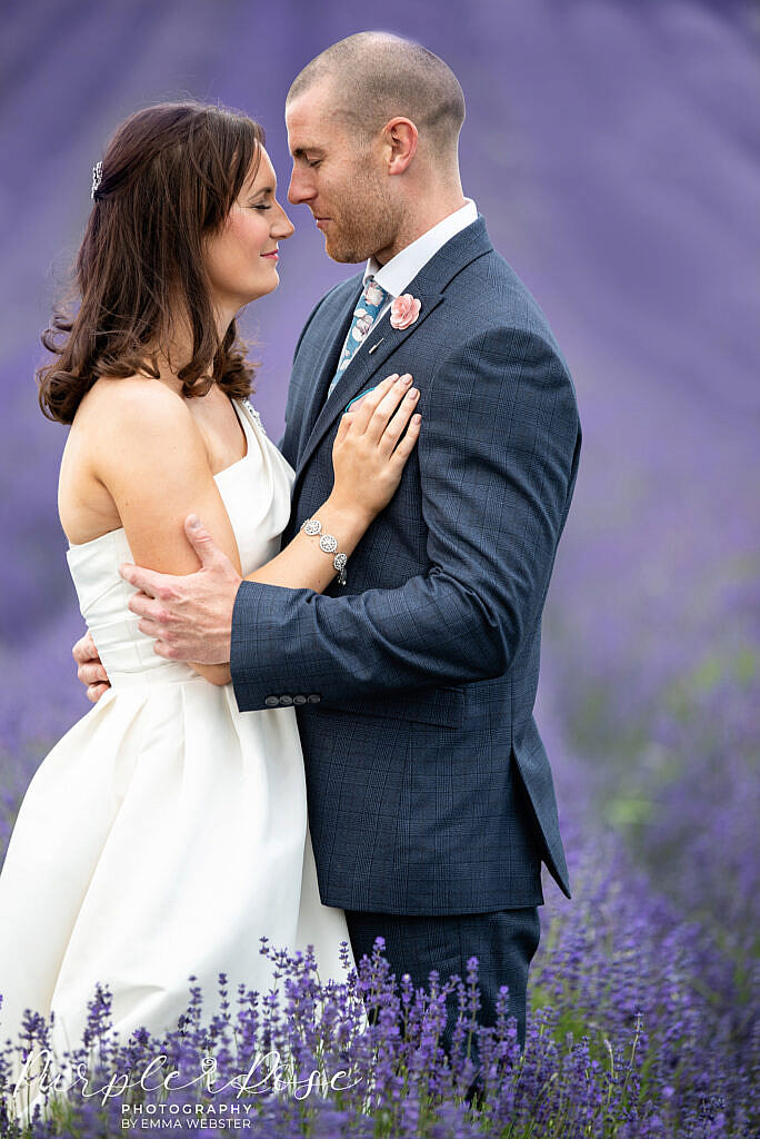 Bride and groom standing in Lavender field