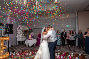 Bride and groom dancing under confetti at their wedding in Milton Keynes