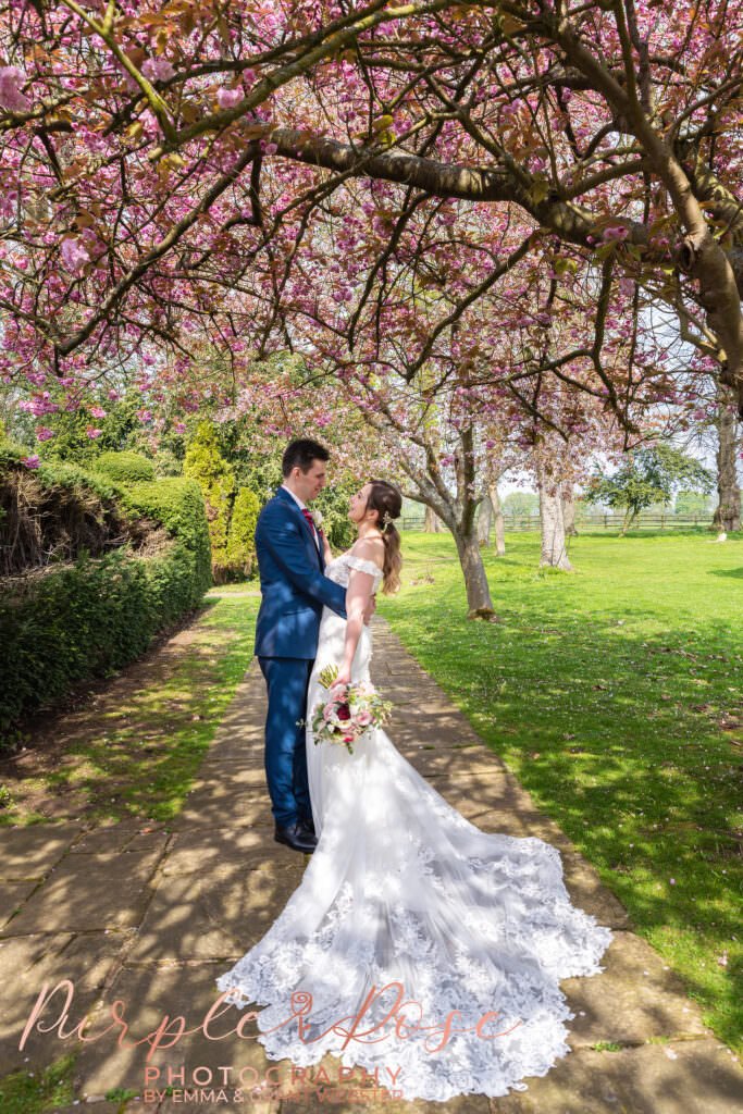 Photo of a bride and groom under dappaled light on their wedding day in Milton Keynes
