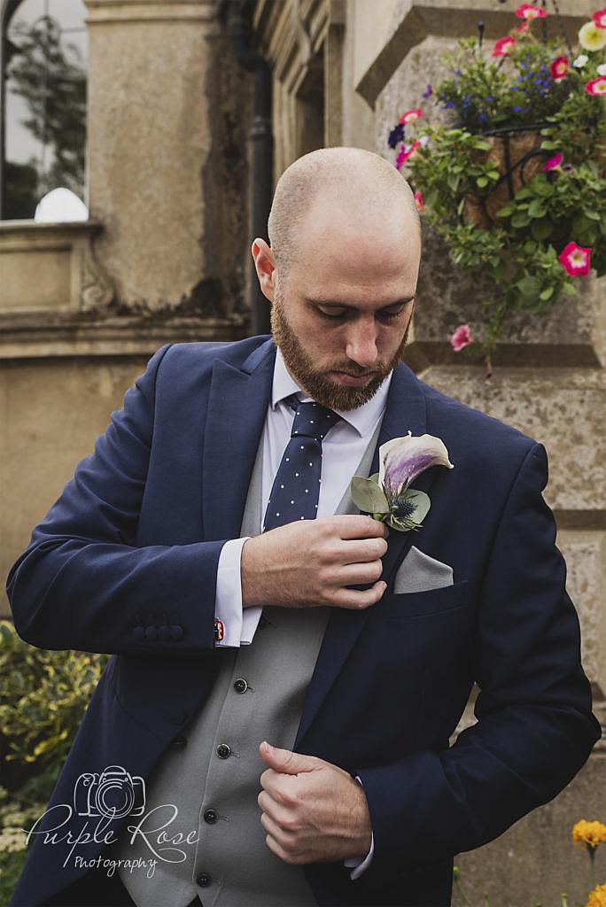 Groom checking his buttonhole