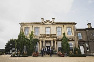 Groomsmen in front of their wedding venue