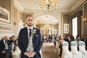 Groom waiting for his bride in the wedding ceremony room