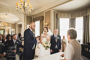 Bride laughing during the wedding ceremony