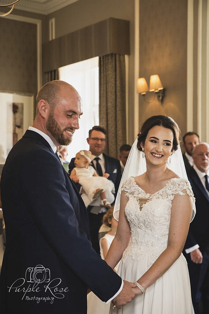 Bride and groom smiling during wedding ceremony