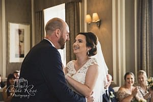Bride and groom laughing during wedding ceremony