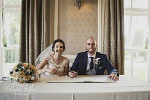 Bride and groom signing the registra