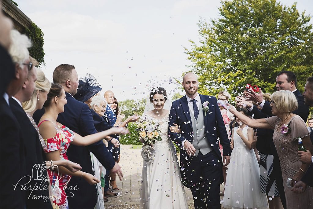 Bride and groom being congratulated by their guests