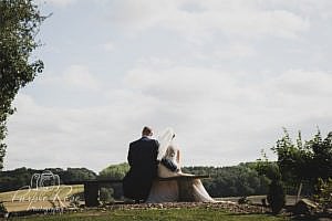 Bride and groom sitting on a bench