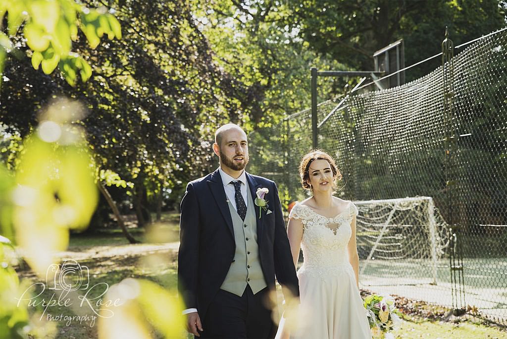 Bride and groom walking to their wedding reception