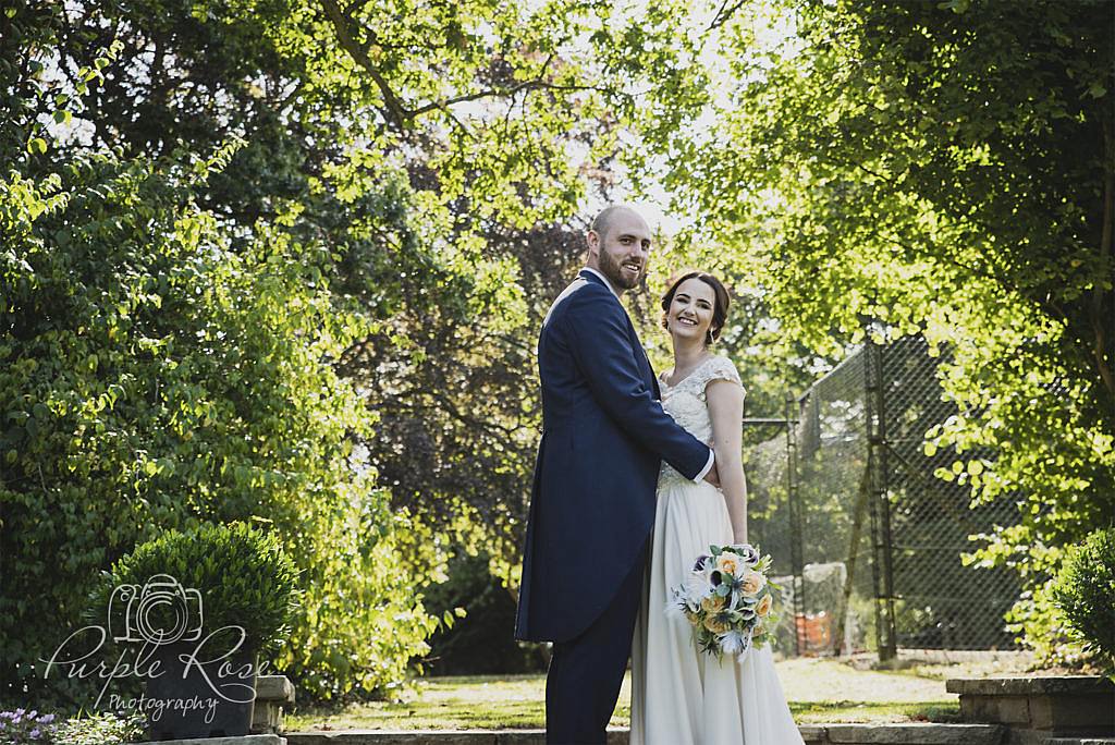 Bride and groom embracing on steps