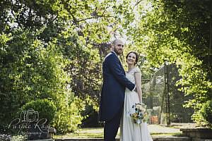 Bride and groom standing in a garden