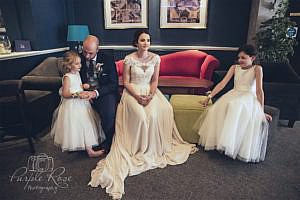 Bride, groom and their children sitting together