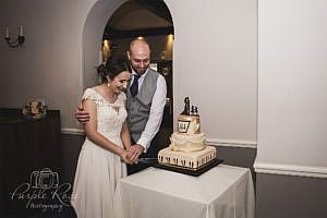 Bride and groom cutting their wedding cake