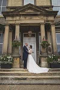 Bride and groom standing together on steps