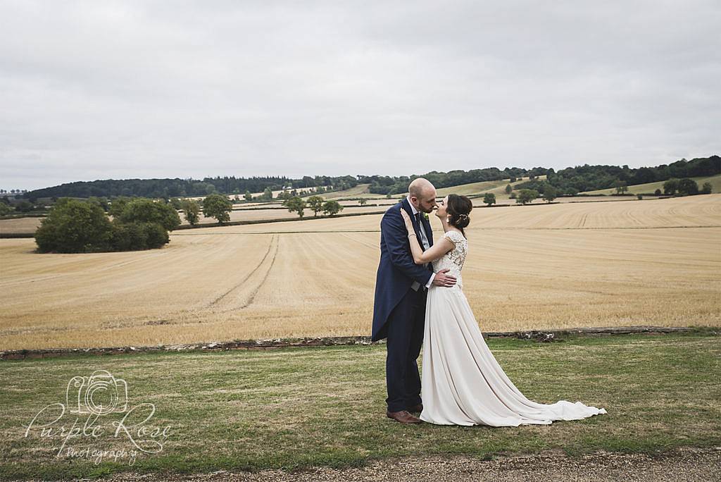 Bride and groom in front off an open field