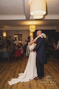 Bride and groom looking into each others eyes while dancing