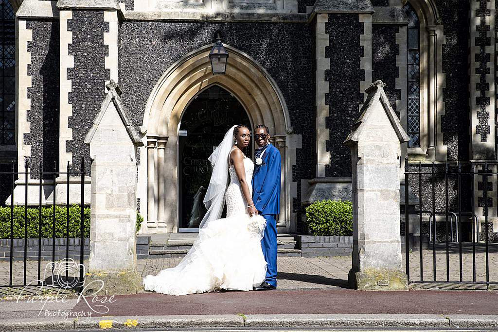 Bride and groom standing in front of their church