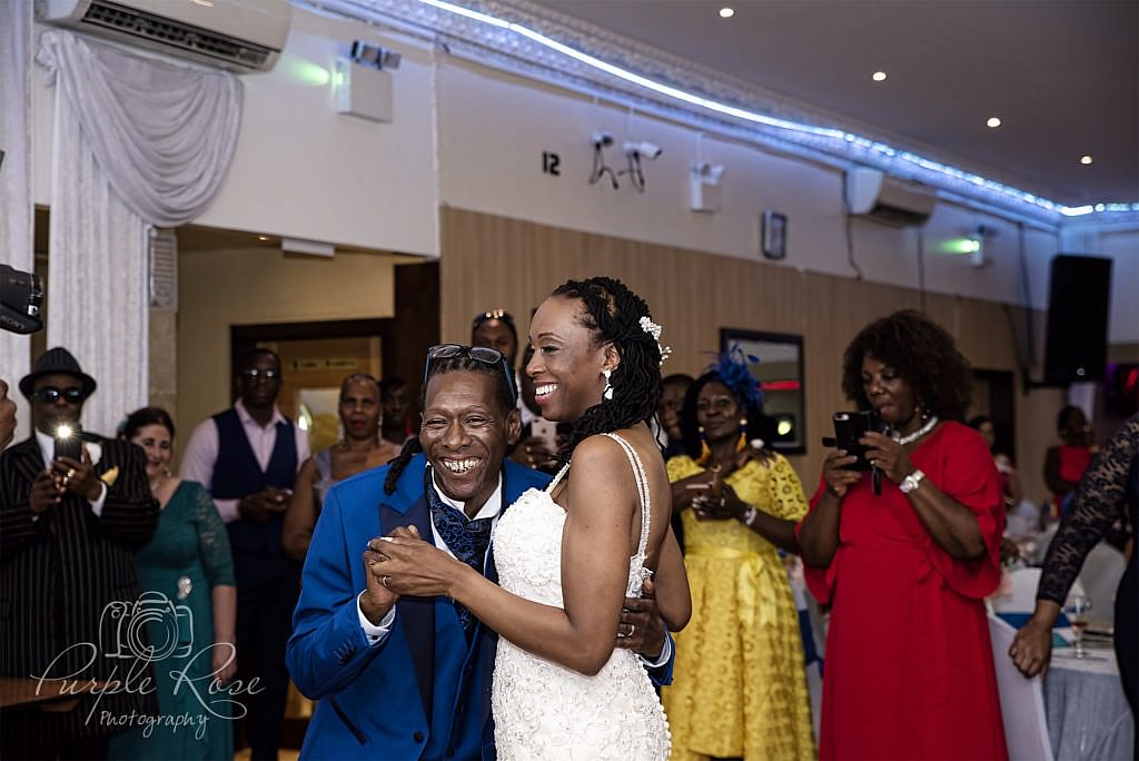 Bride and groom giggling as they dance