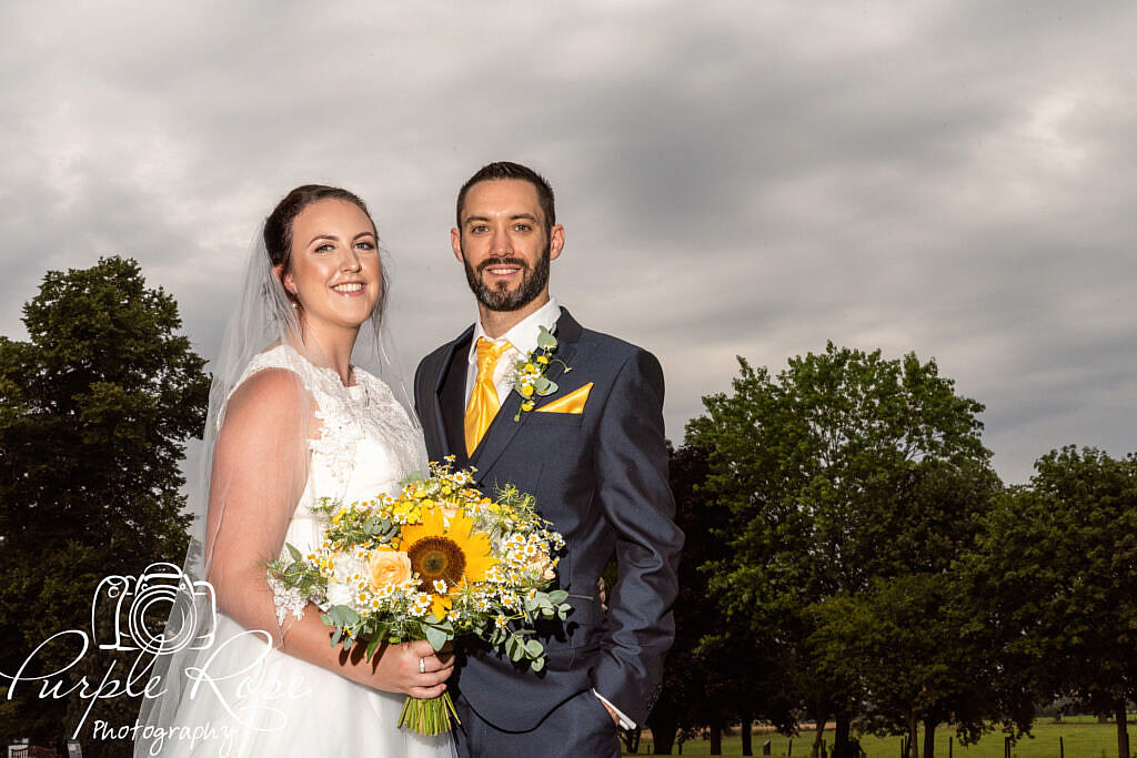 Bride and groom in front of a stormy sky