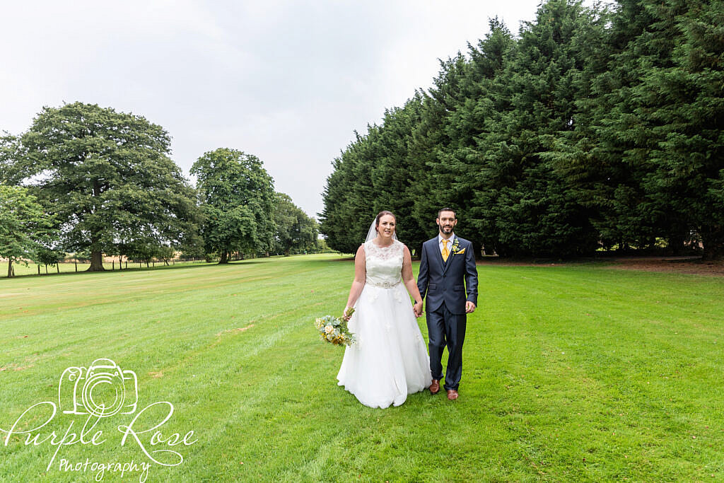 Bride and groom walking hand in hand