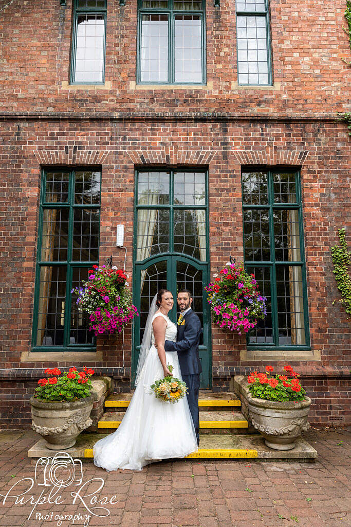 Bride and groom in front of a green door